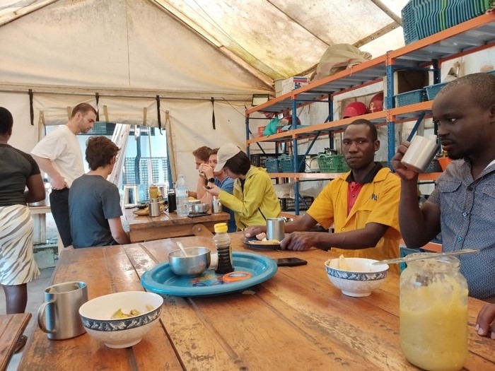 A group of people sitting at a tableDescription automatically generated with low confidence